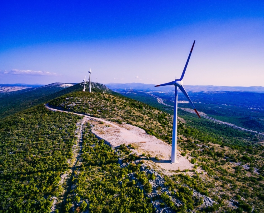 Wind turbines. Aerial view of windmills on green hill in Croatia.